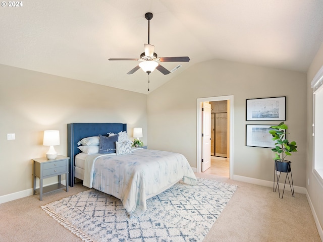 carpeted bedroom with lofted ceiling, ceiling fan, and ensuite bath