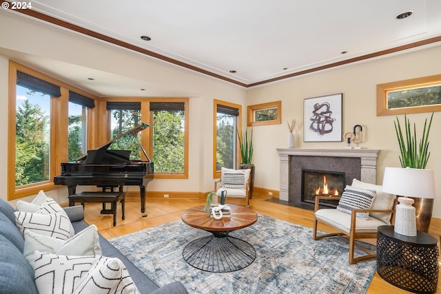 living area featuring light hardwood / wood-style flooring and ornamental molding