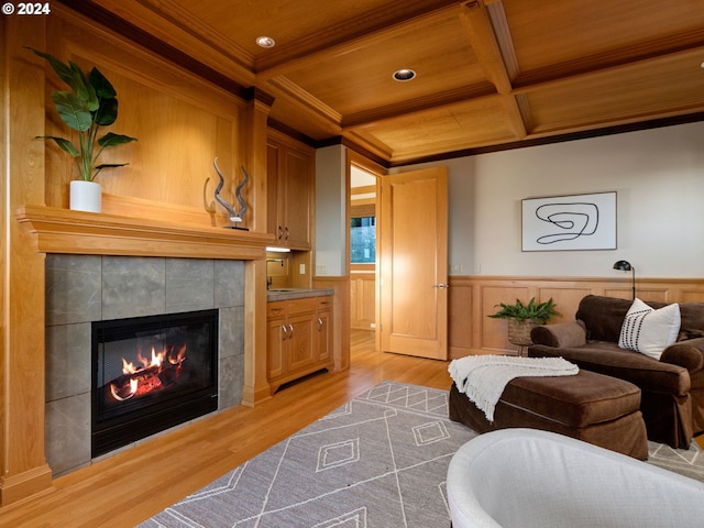 living room with wood ceiling, coffered ceiling, light hardwood / wood-style flooring, and a fireplace