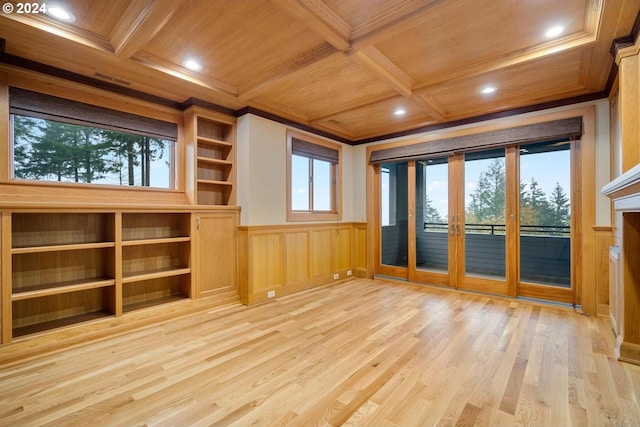 unfurnished living room featuring wood ceiling, light wood-type flooring, beamed ceiling, coffered ceiling, and crown molding