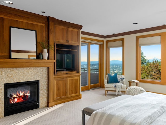 bedroom with ornamental molding, multiple windows, light colored carpet, and access to outside