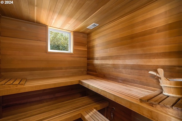 view of sauna with wood walls and wooden ceiling