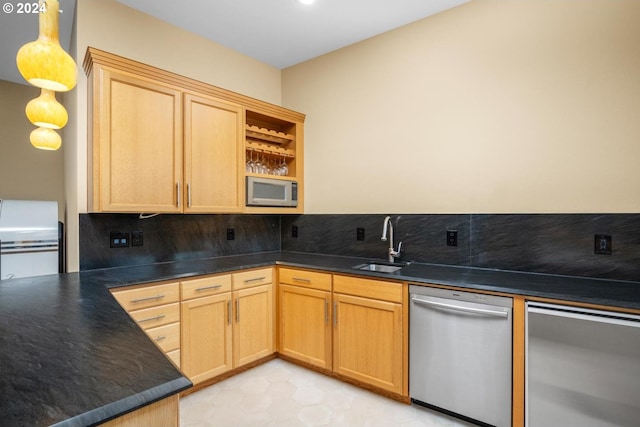 kitchen featuring light brown cabinets, sink, decorative light fixtures, stainless steel appliances, and decorative backsplash