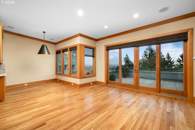 unfurnished living room featuring light hardwood / wood-style flooring and crown molding