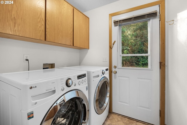 laundry room with cabinets and washing machine and dryer