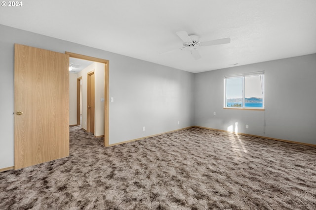 empty room with carpet and ceiling fan