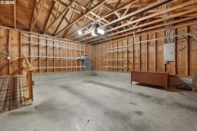 garage with a garage door opener and electric panel