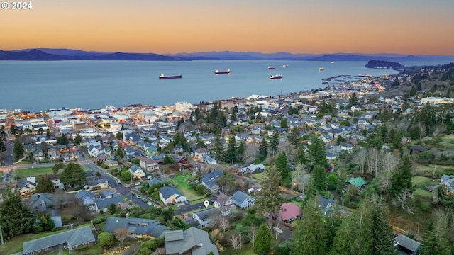 aerial view at dusk with a water and mountain view