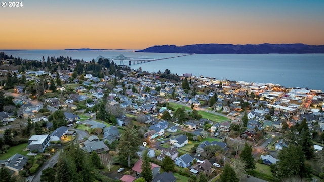 aerial view at dusk with a water view