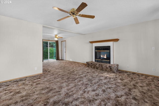 unfurnished living room featuring carpet and ceiling fan