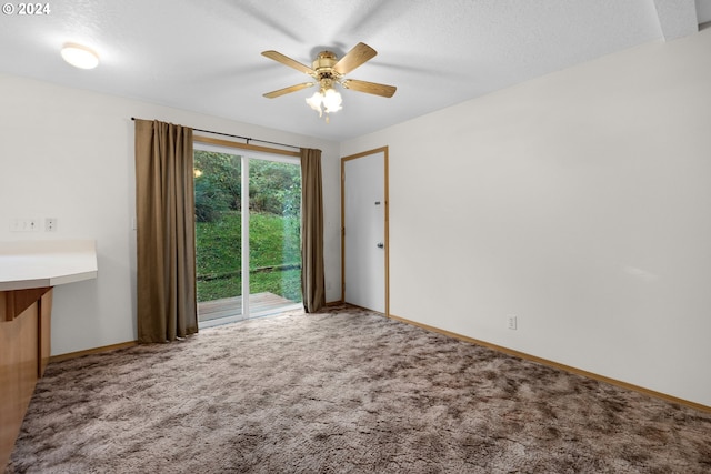 carpeted empty room with a textured ceiling and ceiling fan