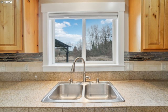 kitchen featuring tasteful backsplash and sink