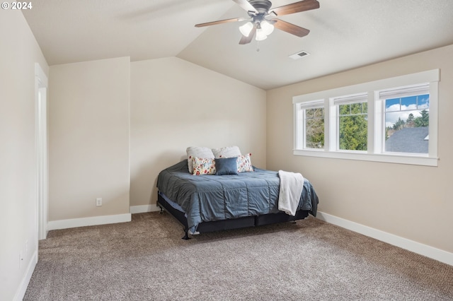 bedroom featuring ceiling fan, vaulted ceiling, and carpet