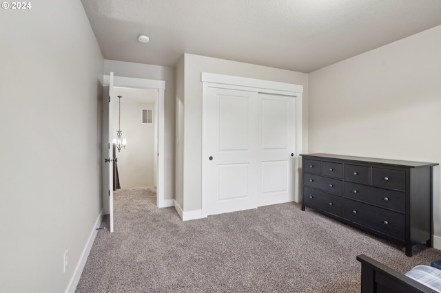 unfurnished bedroom featuring light carpet and a closet