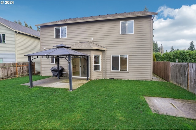 rear view of house with a gazebo, a patio area, and a lawn