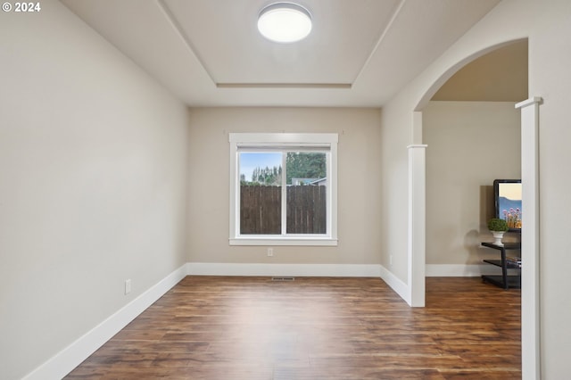 empty room with dark hardwood / wood-style flooring