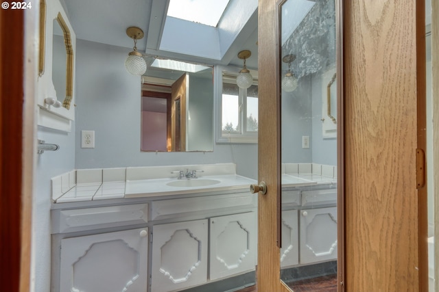 bathroom with vanity and a skylight