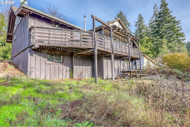 rear view of house with a wooden deck