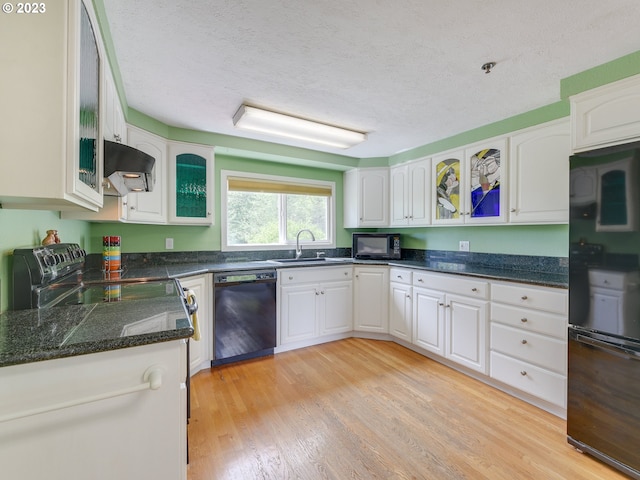 kitchen featuring sink, white cabinets, exhaust hood, black appliances, and a textured ceiling