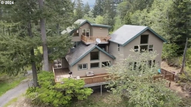 rear view of property with a wooden deck