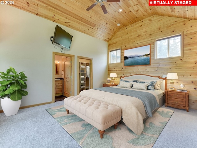 bedroom featuring ensuite bathroom, wood walls, wood ceiling, light carpet, and ceiling fan