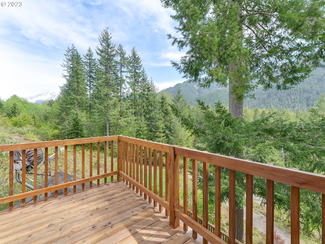 wooden terrace with a wooded view