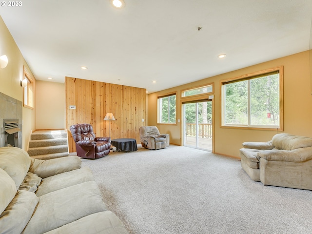 living room with carpet and wood walls