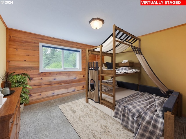 bedroom featuring carpet floors and wood walls