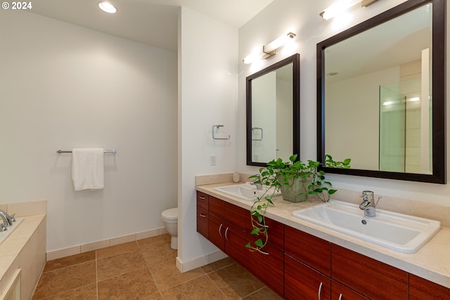 bathroom with vanity, a bath, and toilet