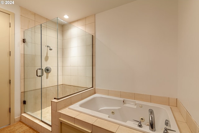 bathroom featuring shower with separate bathtub