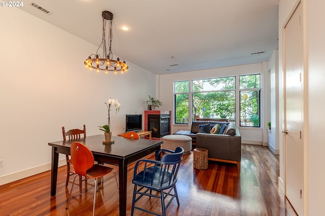 dining area with an inviting chandelier and wood-type flooring