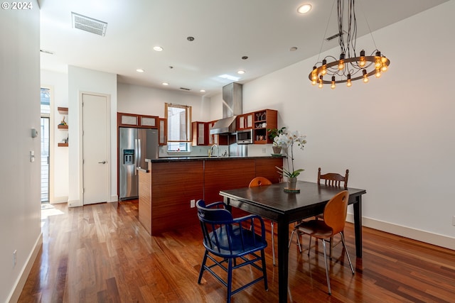 dining space featuring sink and dark wood-type flooring