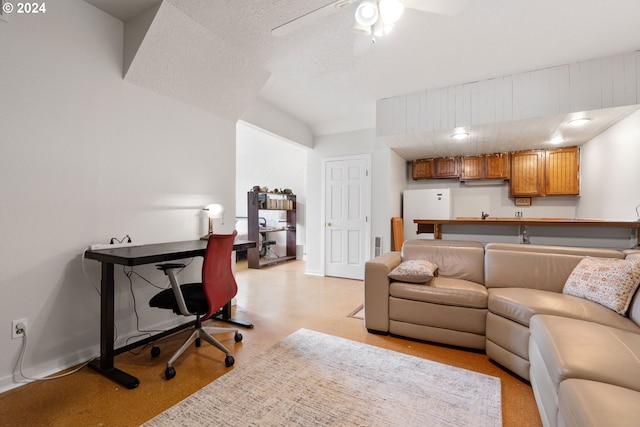 living room featuring a textured ceiling and ceiling fan