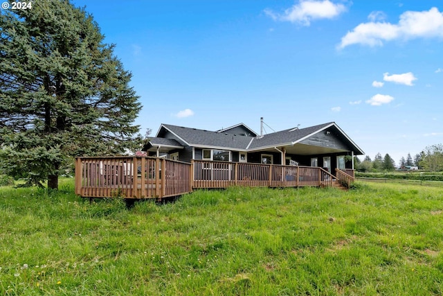 rear view of property with a wooden deck