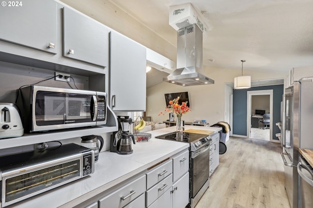 kitchen featuring white cabinetry, pendant lighting, lofted ceiling, island range hood, and appliances with stainless steel finishes