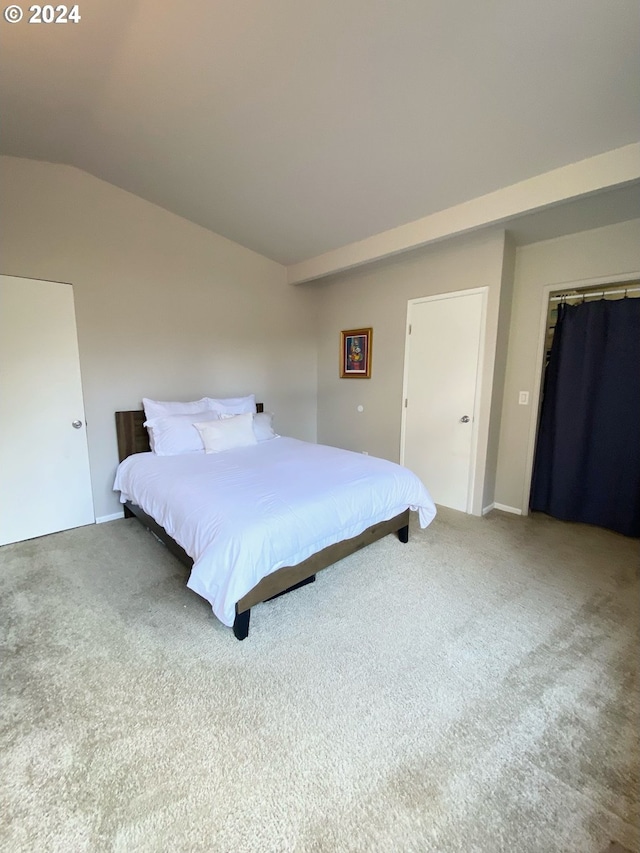 bedroom featuring lofted ceiling and carpet floors