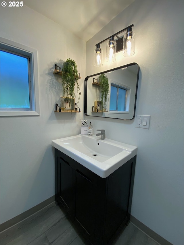 bathroom with vanity and baseboards