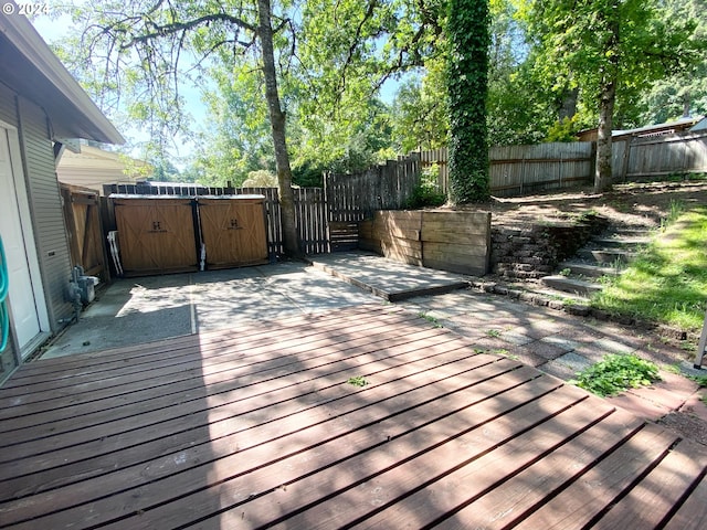 deck featuring a hot tub and a fenced backyard