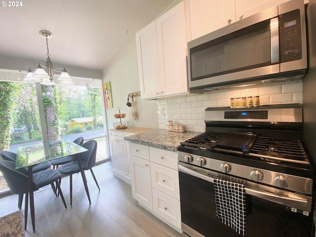 kitchen featuring appliances with stainless steel finishes, backsplash, and white cabinetry