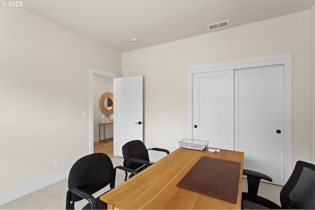 office featuring visible vents, baseboards, and carpet flooring