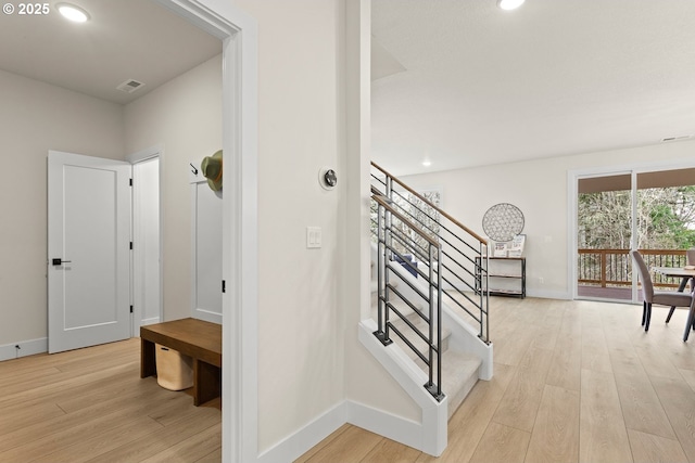 stairs with baseboards, recessed lighting, and wood finished floors