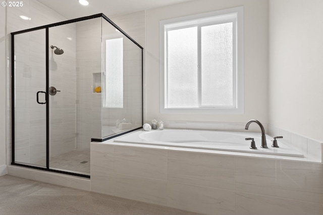 bathroom featuring a garden tub and a stall shower