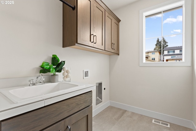 laundry area with hookup for an electric dryer, visible vents, hookup for a washing machine, cabinet space, and a sink