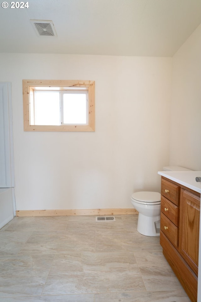 bathroom with baseboards, visible vents, and toilet