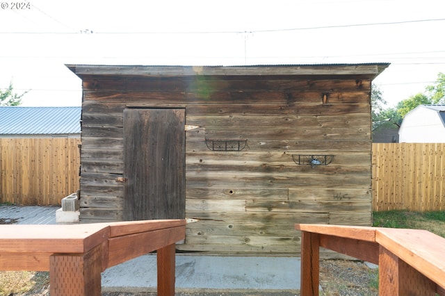 view of outbuilding with fence