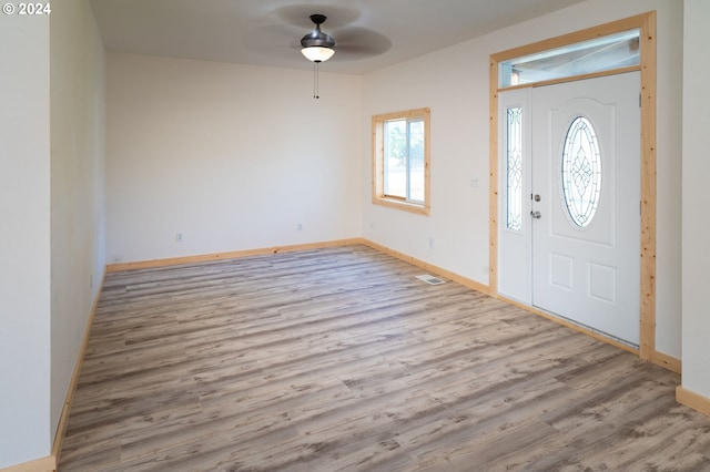 entrance foyer with light wood-style floors, ceiling fan, visible vents, and baseboards