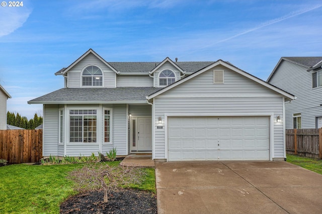 view of front facade with a front yard and a garage