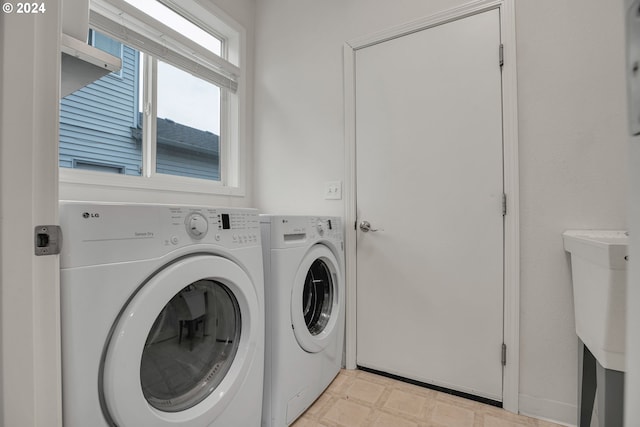 washroom with washing machine and clothes dryer