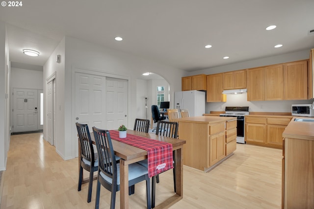 kitchen featuring light brown cabinets, white appliances, and light hardwood / wood-style flooring