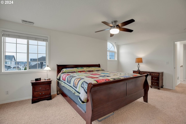 bedroom with ceiling fan and light carpet